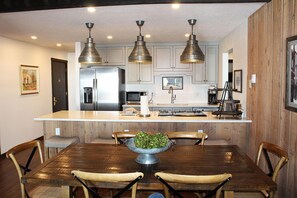 Enjoy meals in this well-equipped kitchen with a central island, oven, and dining area.