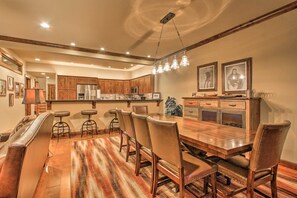 Enjoy meals in this inviting dining area with a long table and comfortable chairs.