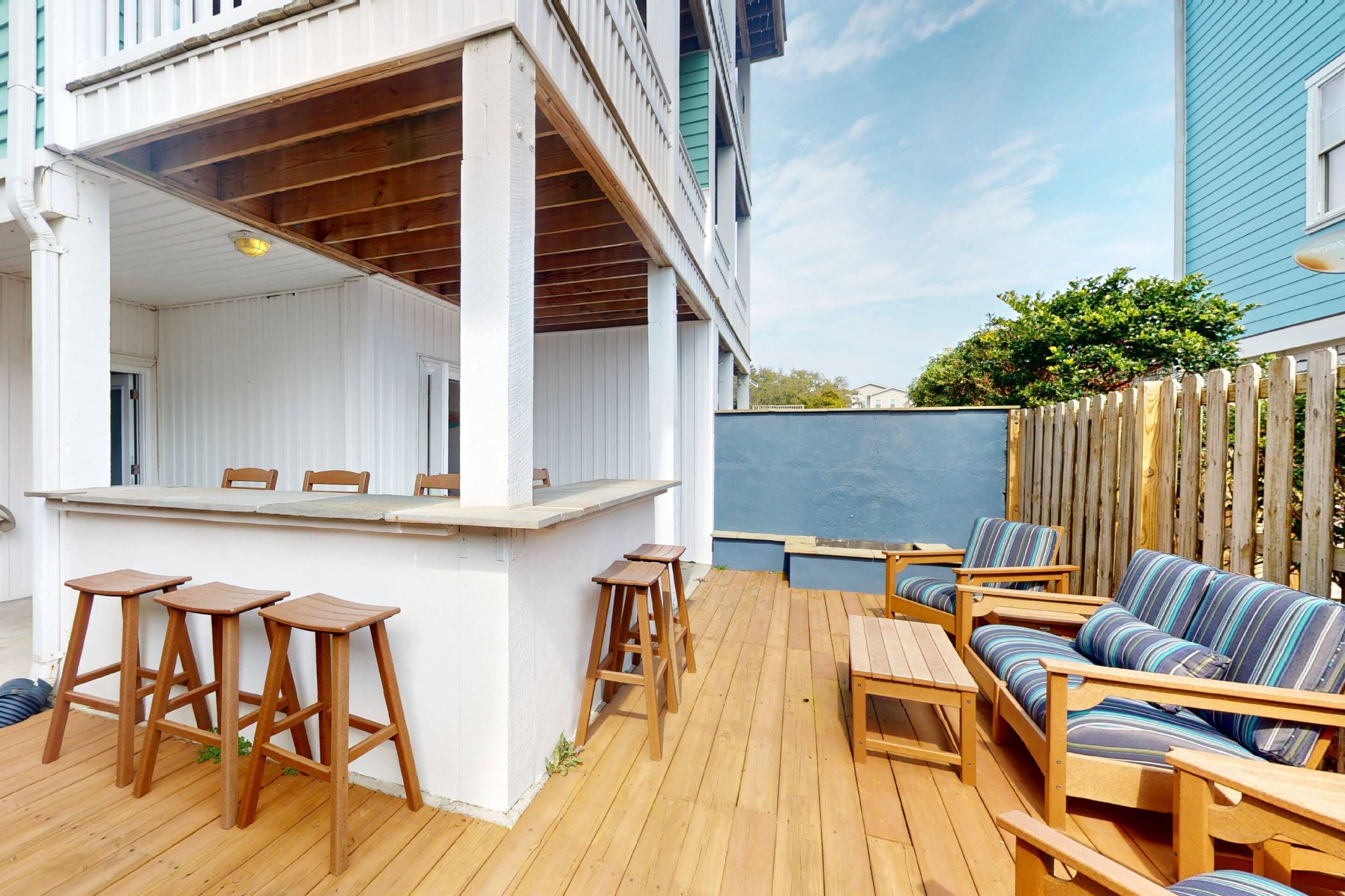 Relax around the outdoor bar and firepit with a cocktail after a long day in the sand