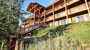 A multi-story building with balconies and a staircase leading to the upper levels. - Great Location! Ski-In/Out Condo. Mountain Views, Fireplace. (Mt. Crested Butte)