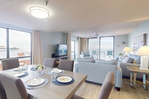 Relax in this stylish room with a dining area, comfortable seating, and a balcony offering a city view.