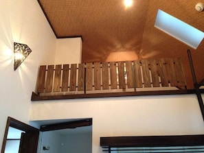 A room with a wooden slatted ceiling, a white wall, and a visible door frame. - Estivant Club (Tsumagoi)