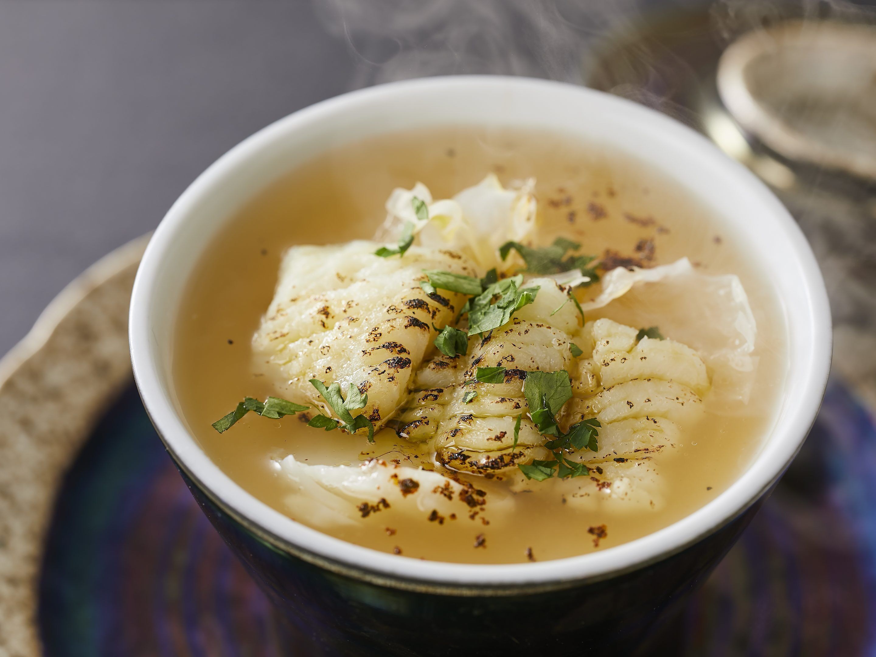 A bowl of soup with a garnish.