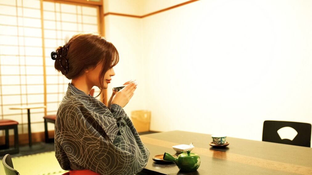 A person seated at a table with a teapot, cup, and saucer.