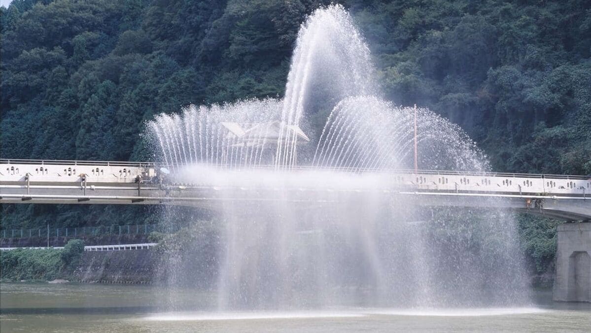 A bridge with a water fountain feature in the foreground.