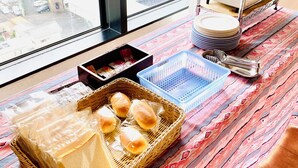 A dining area with a table set for a meal, a toaster, and a view of the outside. - Okazaki Ohwa Hotel (Okazaki)