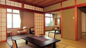 A traditional Japanese room with tatami flooring, a low table, and sliding doors. - Nakamuraya (Toba)