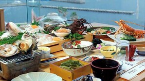 A table set with seafood dishes and a view of a harbor. - Nakamuraya (Toba)