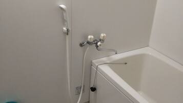 A bathroom with a bathtub, a shower, and a toilet.