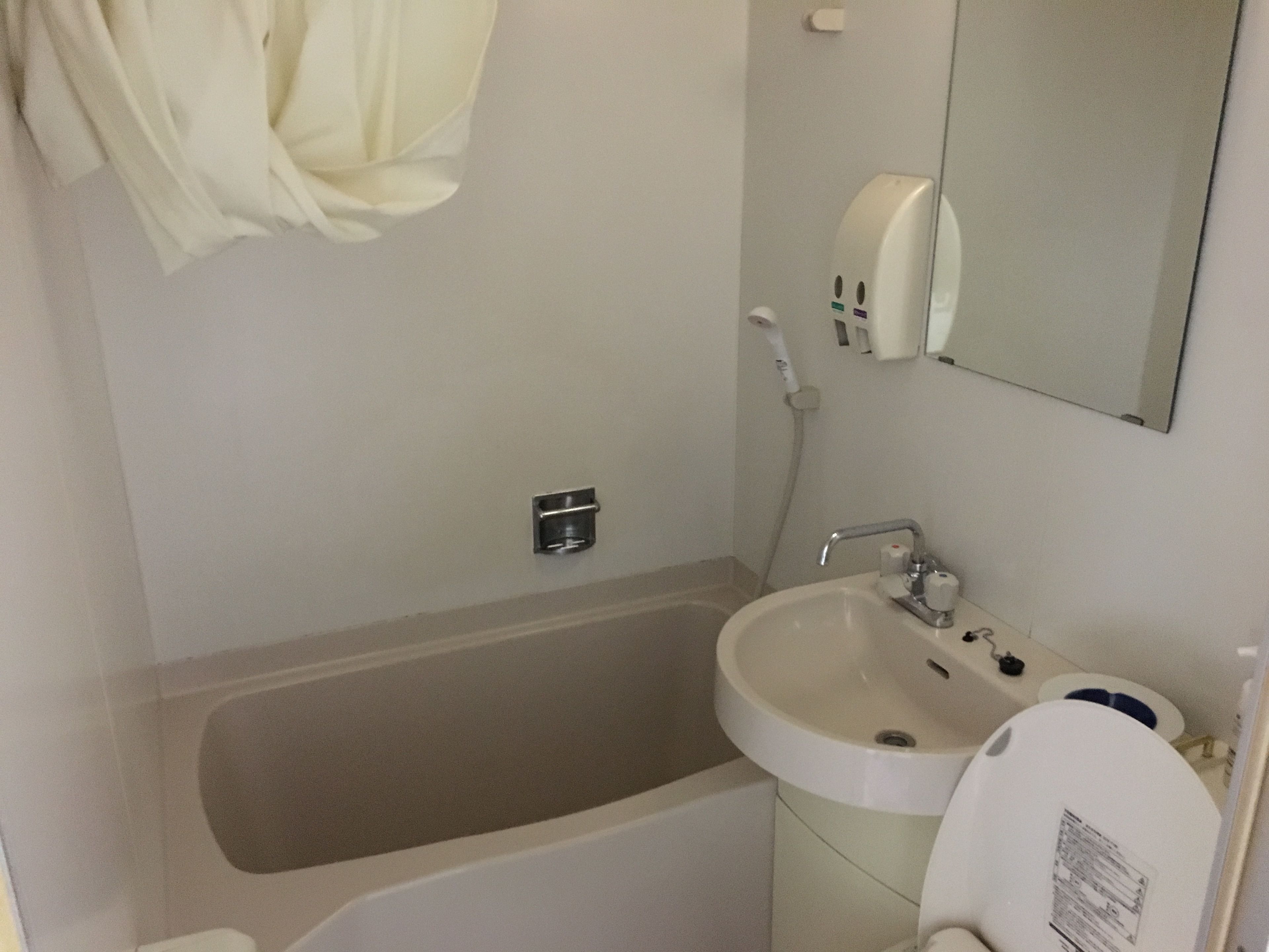 A bathroom with a bathtub, sink, and toilet.
