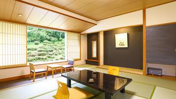 A traditional Japanese room with tatami flooring, a low table, and shoji screens.