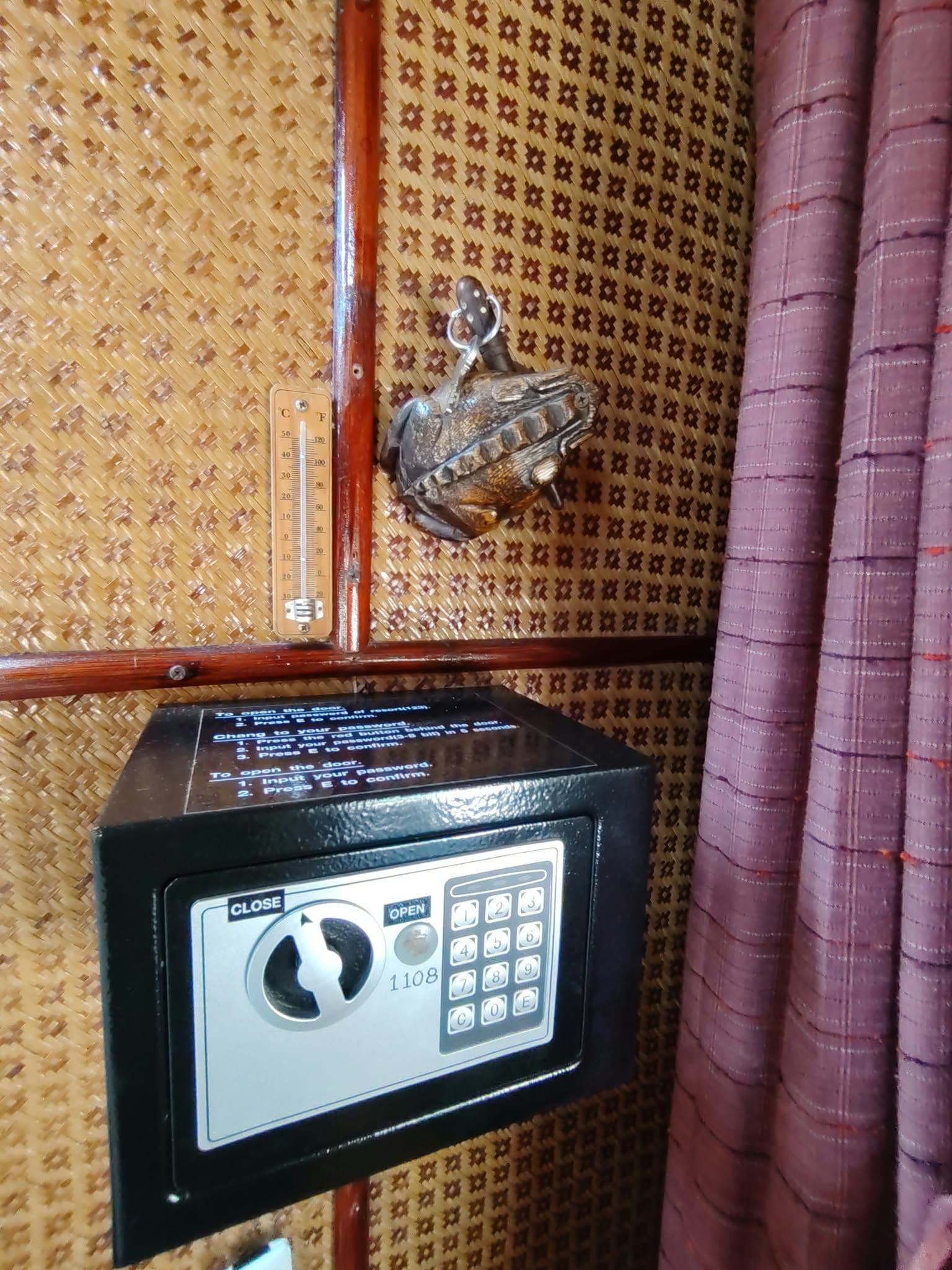 A security keypad lock on a door with a temperature gauge above it.
