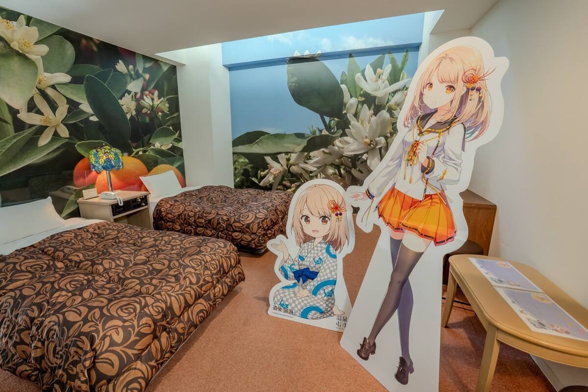 A bedroom with a bed, a desk, and a large window.