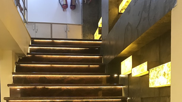 A staircase with illuminated handrails and a fire extinguisher mounted on the wall. - Hotel Gauranga Nearest New Delhi Railway Station (New Delhi)
