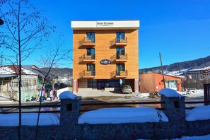 A modern building with a sign that reads "Hotel". - King David Bakuriani (Borjomi)