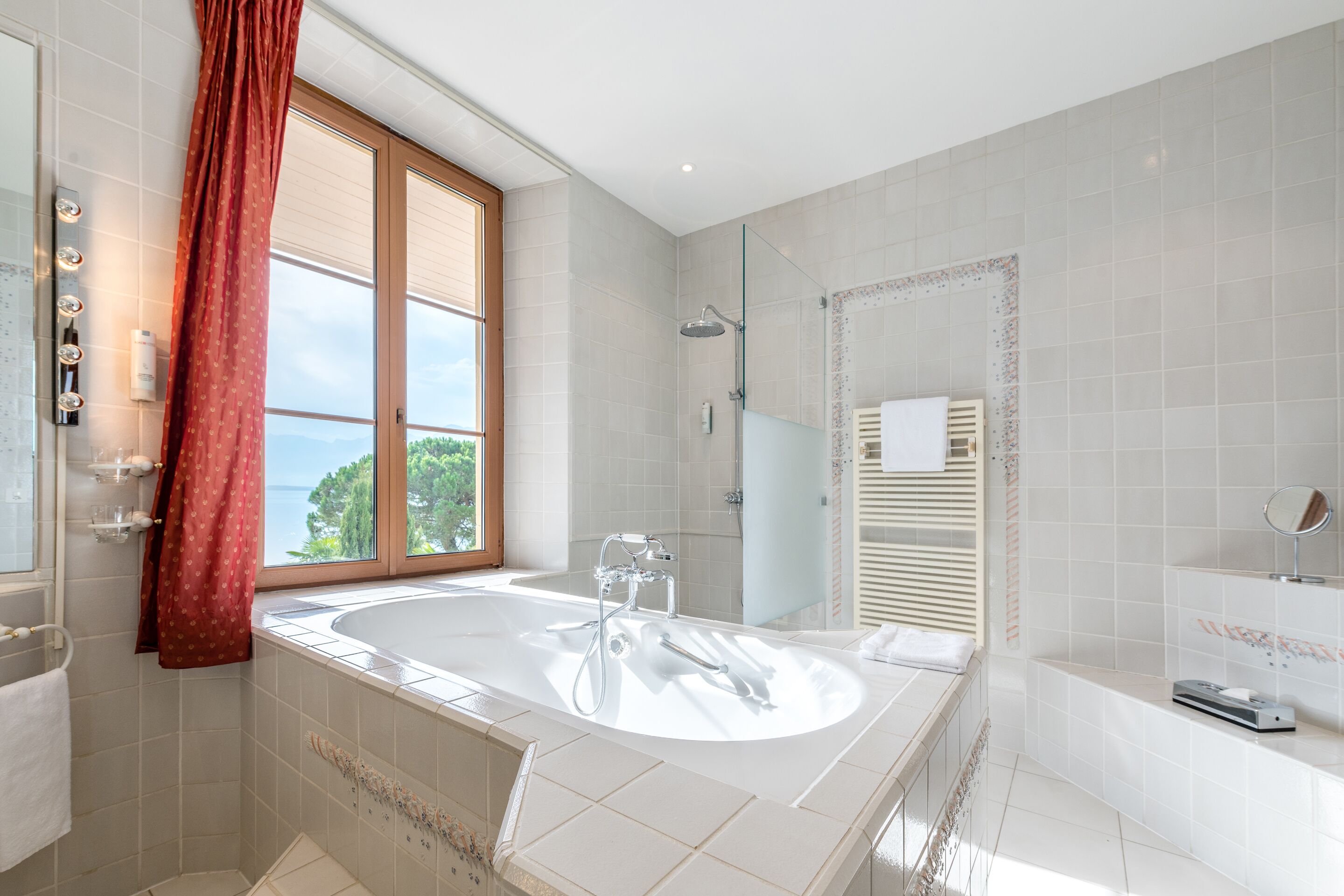 junior suite, lake view | bathroom | free toiletries, towels