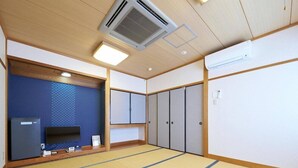 A room with tatami flooring, a television, a refrigerator, and a wardrobe. - Hotel Areaone Wadayama (Asago)