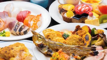 A variety of dishes including fish, vegetables, and desserts on a table.