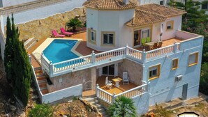 A multi-story house with a swimming pool, balconies, and outdoor seating areas. - Modern, well maintained villa with stunning sea views, private pool, Wi-Fi, air conditioning (Denia)