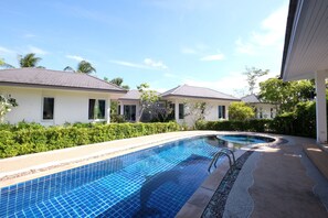 A residential area with a swimming pool, houses, and greenery. - Yokyor Resort (Sikao)