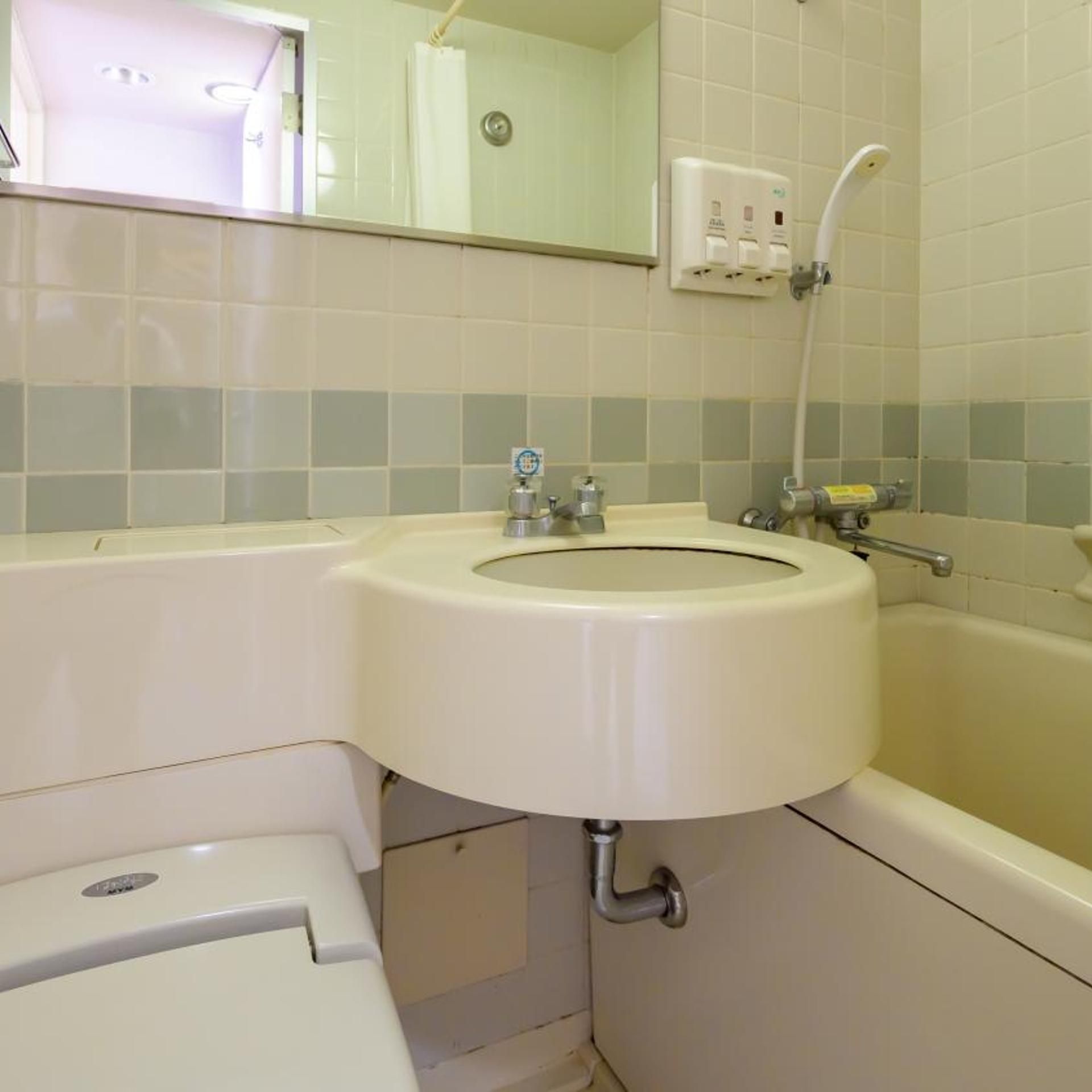 A bathroom with a sink, toilet, and bathtub.