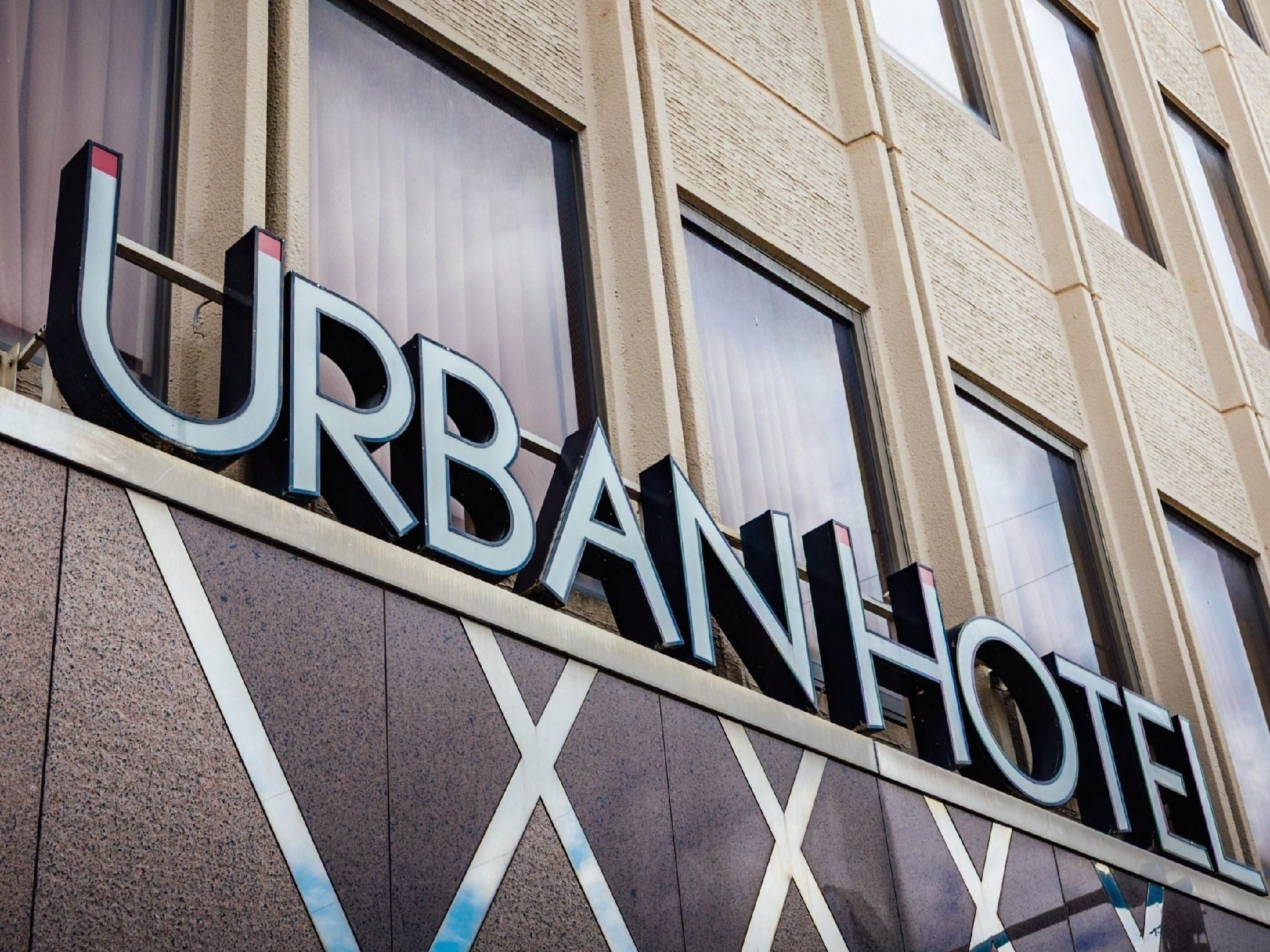 A building facade with the words 'URBAN HOTEL' prominently displayed.
