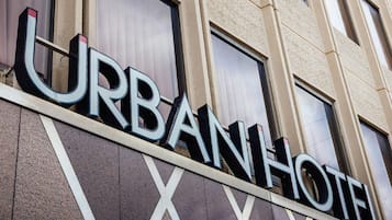 A building facade with the words 'URBAN HOTEL' prominently displayed.