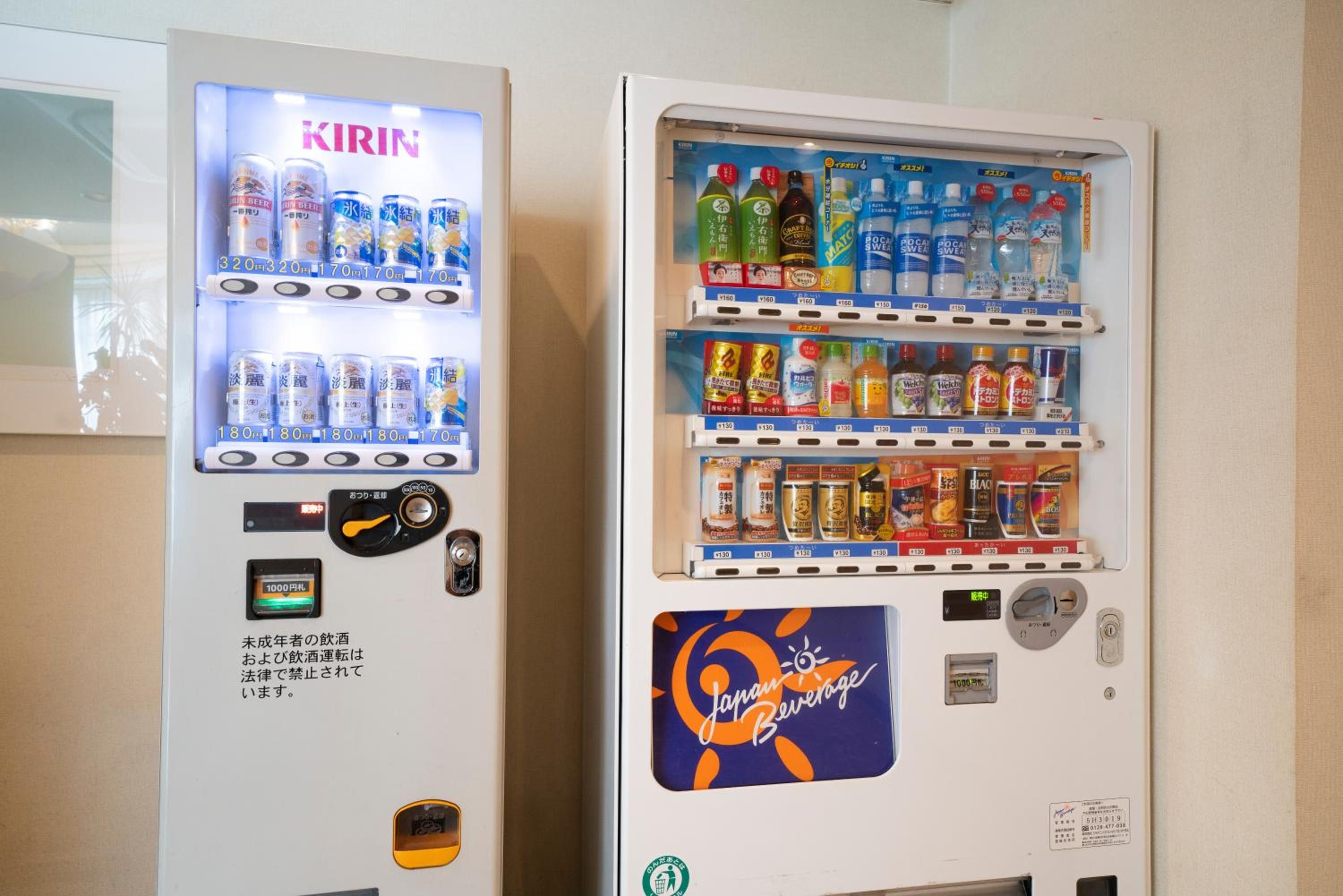 Two beverage vending machines with various drink options.