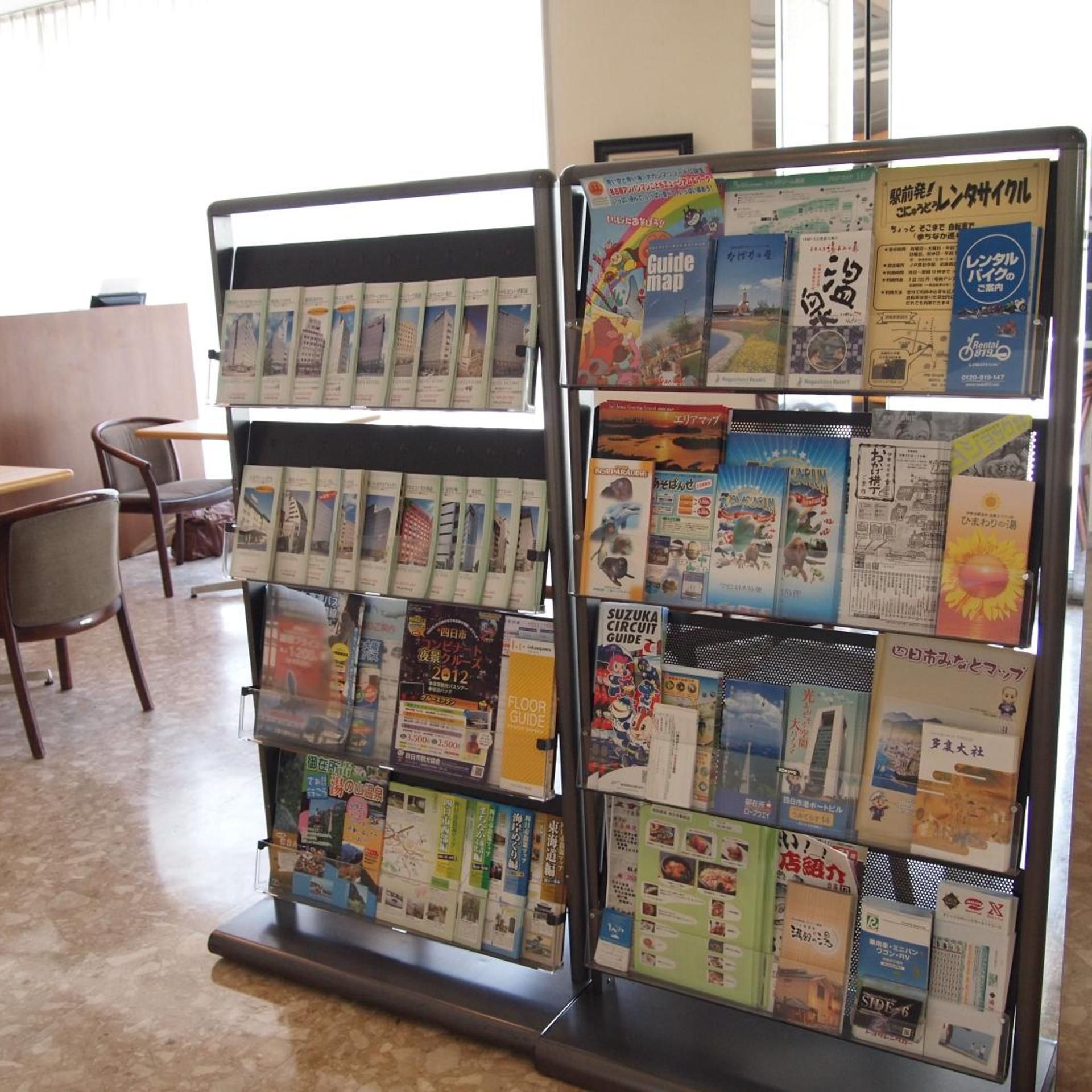 A display rack with various travel guides and maps.