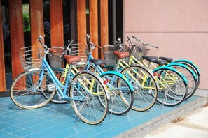 A row of bicycles parked outside a building with a tiled floor. - Wakasamikata Kirara Onsen Hotel Suigekka (Wakasa)
