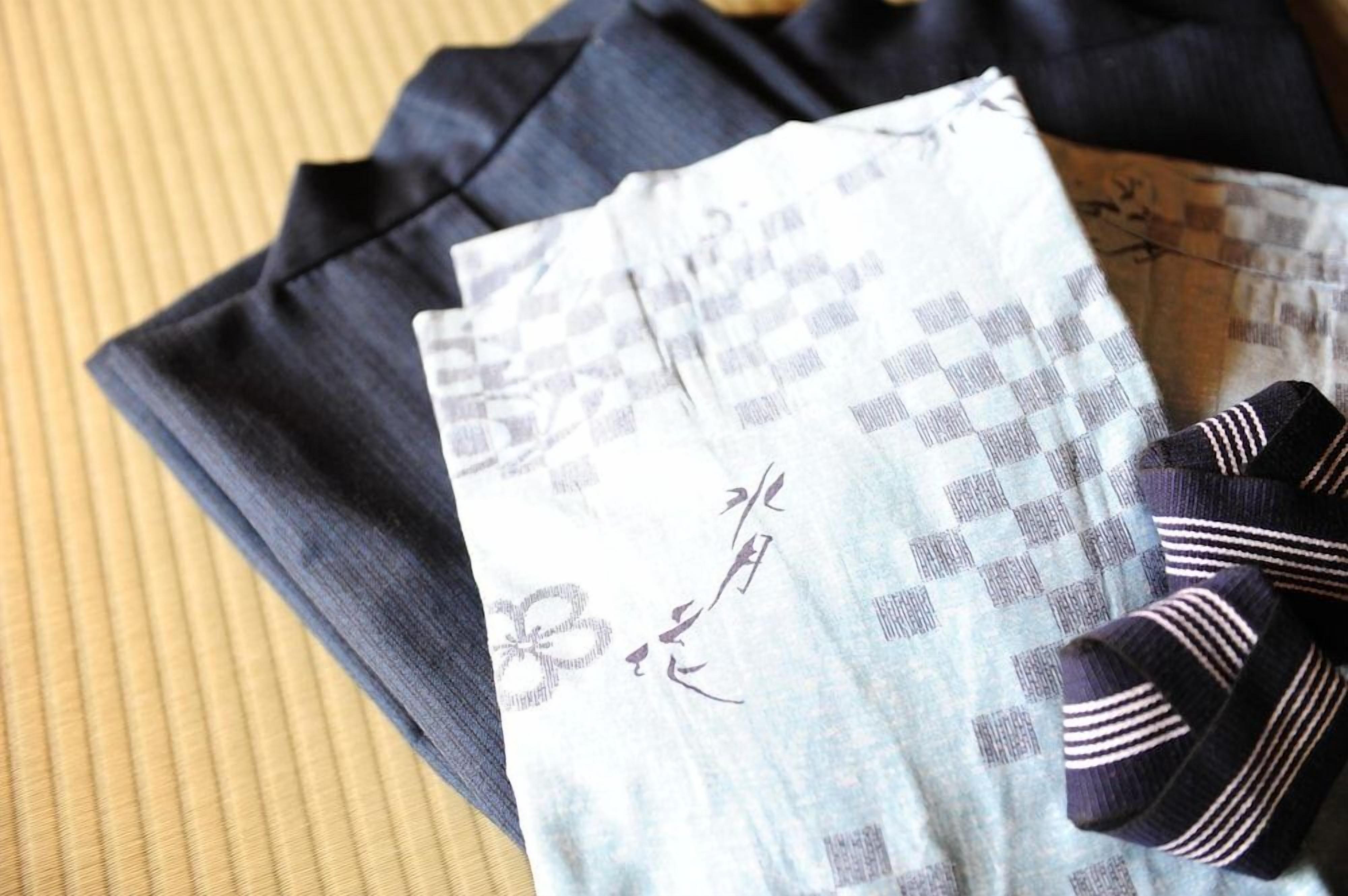A folded piece of clothing with a checkered pattern and a pair of striped socks.