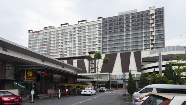 A multi-story hotel with a modern design, featuring a prominent 'GMP' sign on the building. - Hotel Holmes GP (Gelang Patah)
