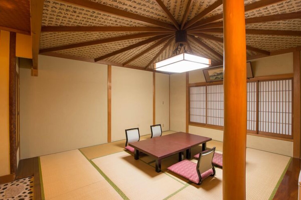 A traditional Japanese room with tatami flooring, a low table, and shoji screens.