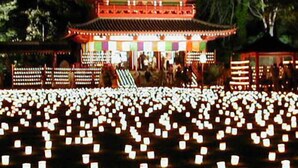 A traditional Japanese building with multiple tiers and a courtyard filled with lanterns. - Ayame-ryokan (Itako)