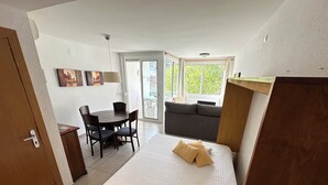 A bedroom with a bed, a small desk, and a sofa. - Voramar 2A - One Bedroom Apartment, Sleeps 4 (Roses)