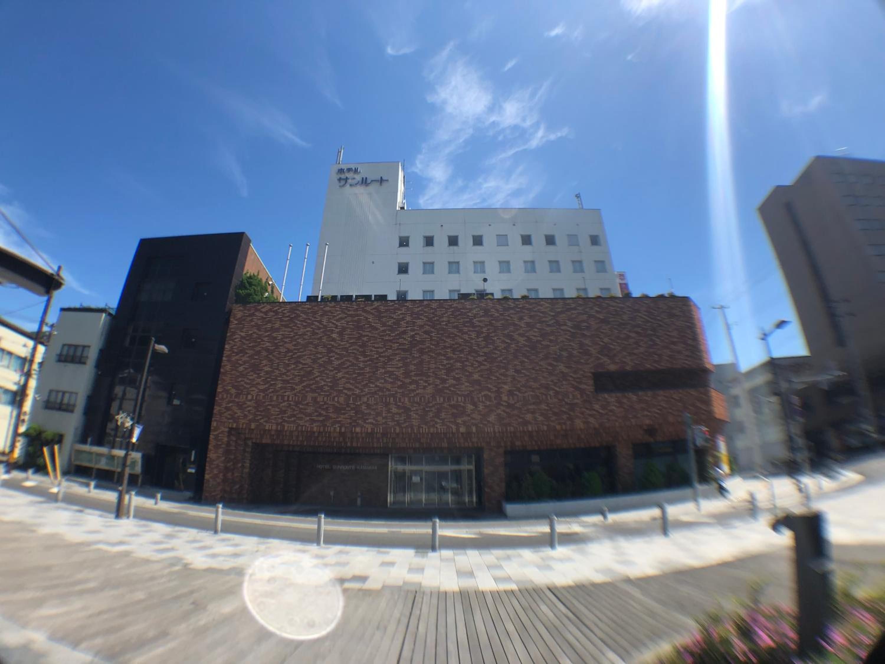A hotel with a modern design, featuring a brick facade and a flat roof.