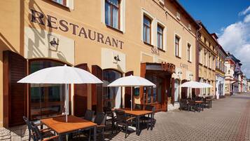 Enjoy a meal under the shade of a white umbrella at this traditional restaurant.