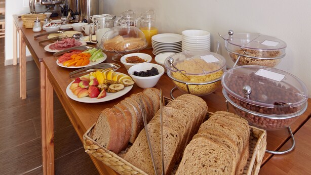 A buffet with various food items including fruits, bread, and beverages. - Ski Hotel Svoboda nad Upou (Svoboda nad Upou)
