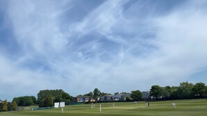 A grassy field with buildings and trees in the background. - The White Swan (Leeds)