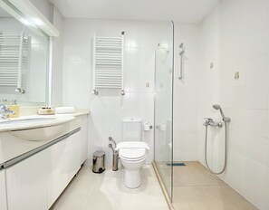 Une salle de bain moderne équipée de toilettes, d’un lavabo et d’une douche.