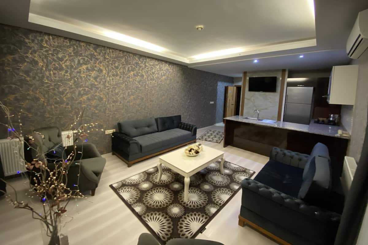 Deluxe Suite, Multiple Bedrooms, City View | Living area | LCD TV