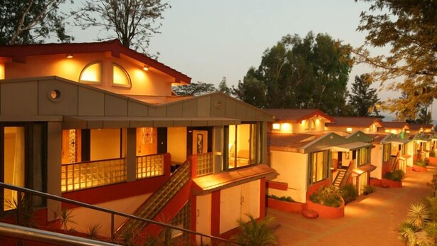 A row of hotel buildings with multiple stories, each featuring balconies and staircases.