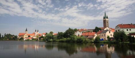 A riverside town with historic buildings and a prominent church tower.