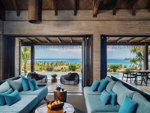 Five Bedroom Ocean View Pool Residence | Living area | 48-inch flat-screen TV with satellite channels, TV, books - Six Senses Fiji (Malolo Island)