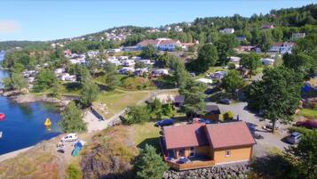 A coastal residential area with houses, a dock, and a small boat.