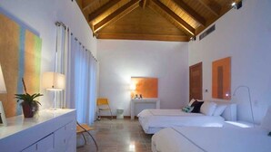A hotel room with two beds, a desk, a chair, a lamp, and a potted plant. - Villa Perla by Unlimted Luxury Villas (La Romana)
