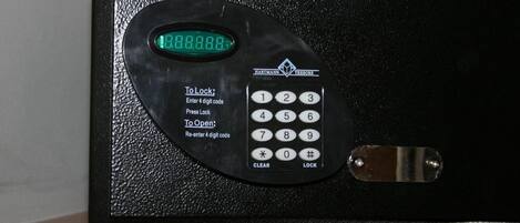 A black electronic safe with a digital display and a keypad.