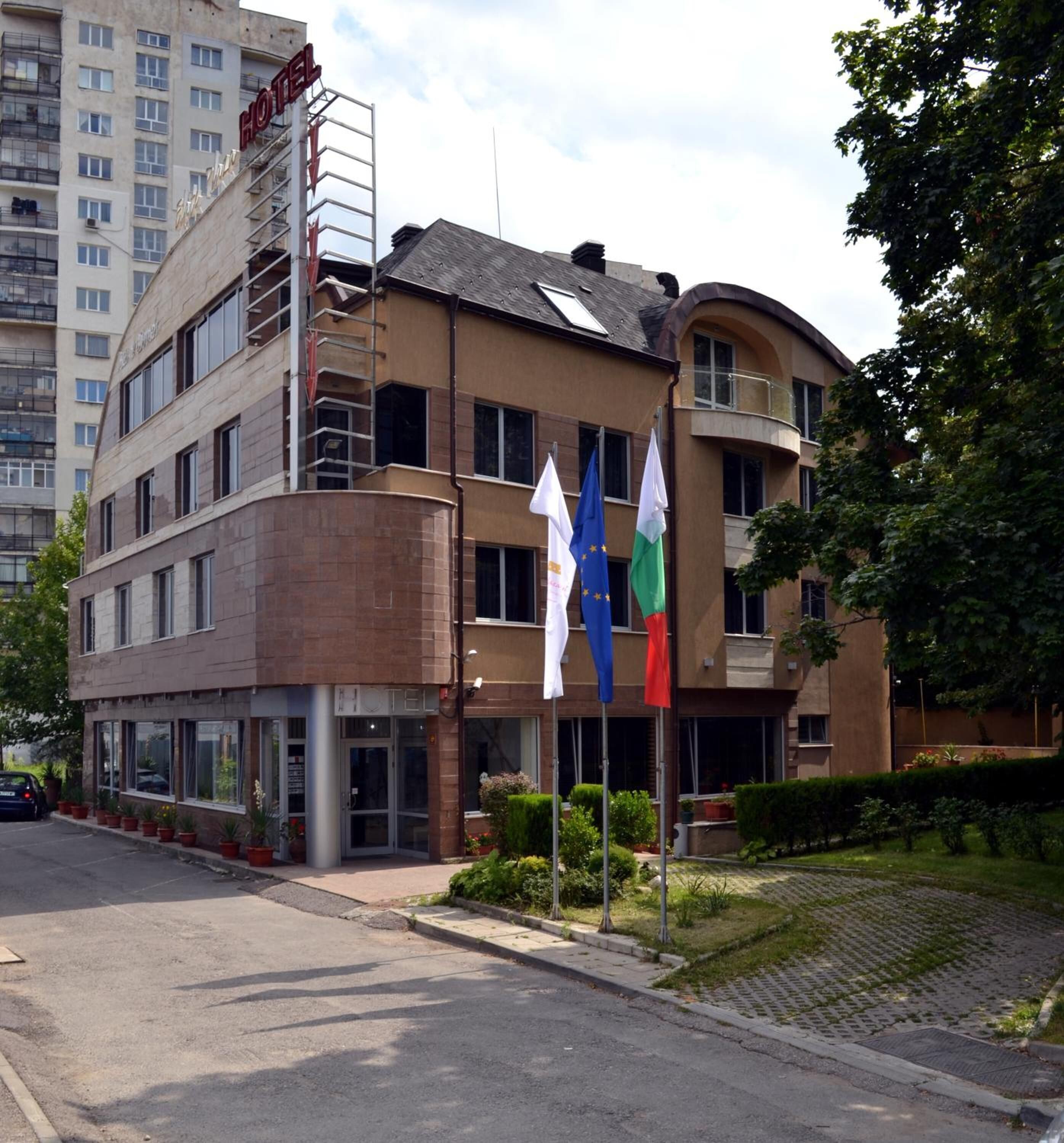 A hotel with a modern design, featuring a prominent 'HOTEL' sign on the facade.