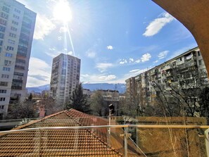 A high-rise building with a tiled roof and a clear sky.