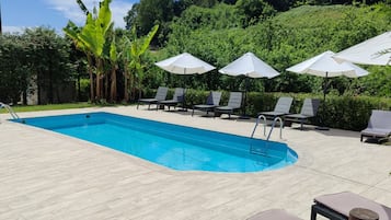 Seasonal outdoor pool, open 11:00 AM to 7:30 PM, pool umbrellas
